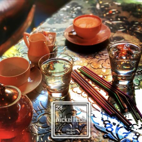 Brand Design Tea and glass cups on a decorative table with colourful straws.