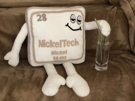 Custom Mascot production A plush representation of nickel, smiling and holding a glass.